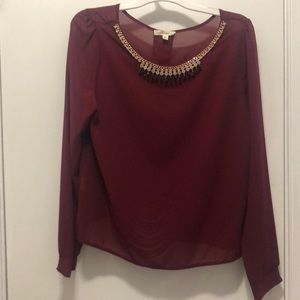 Red blouse with necklace detail